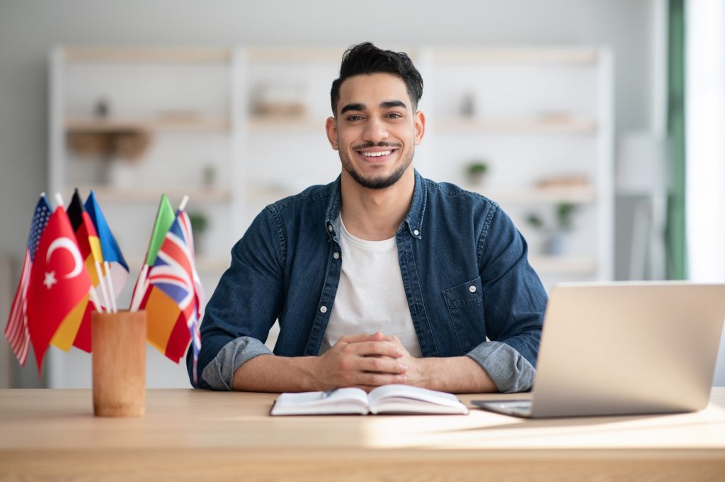 cheerful-arab-guy-having-online-class-on-laptop-at-home.jpg